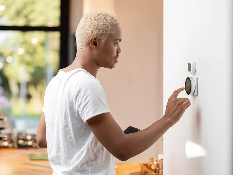 Person using a smart thermostat