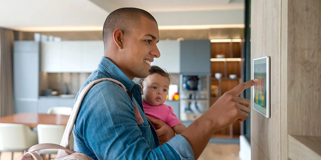 Father and child using a smart thermostat