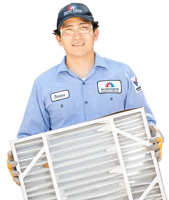 Service Experts technician holding air filter
