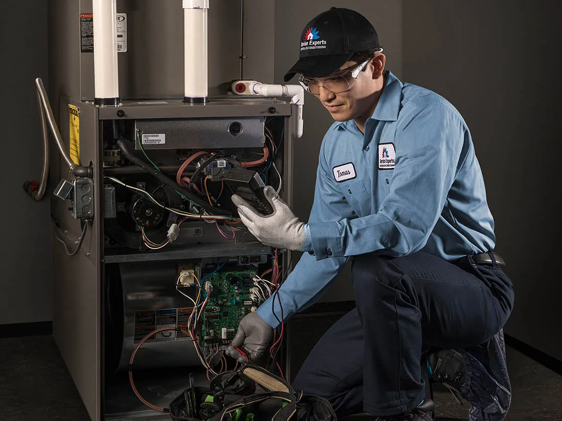 Service Experts technician repairing a furnace