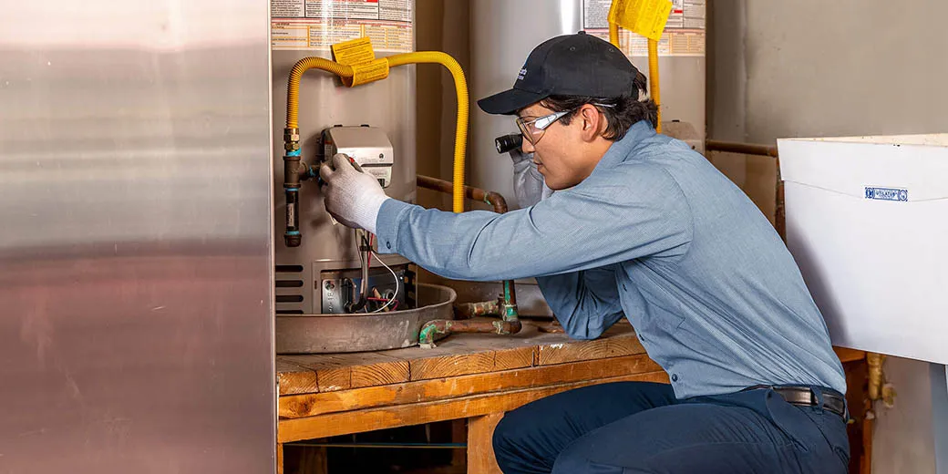 A Service Experts technician inspecting a furnace
