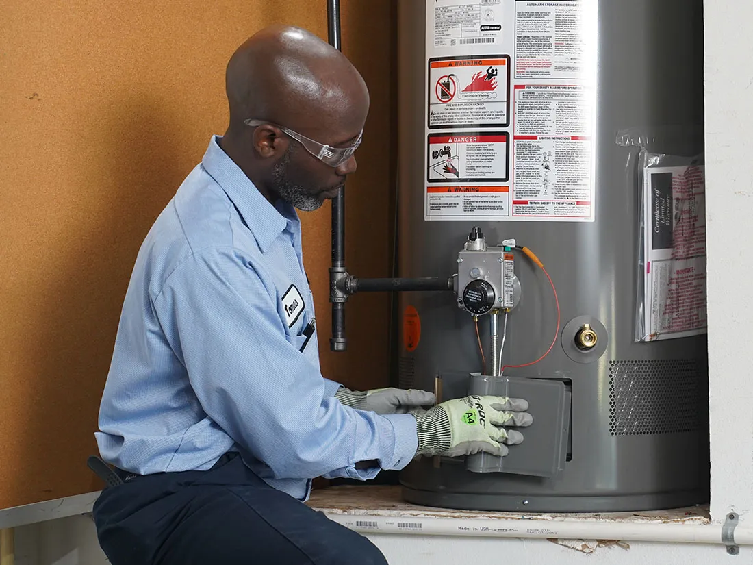 Service Experts technician servicing a water heater