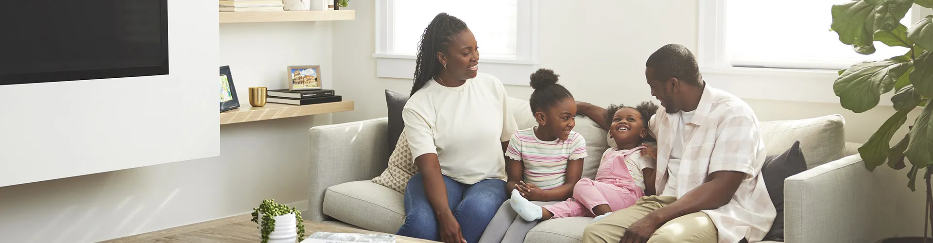 family smiling on the couch